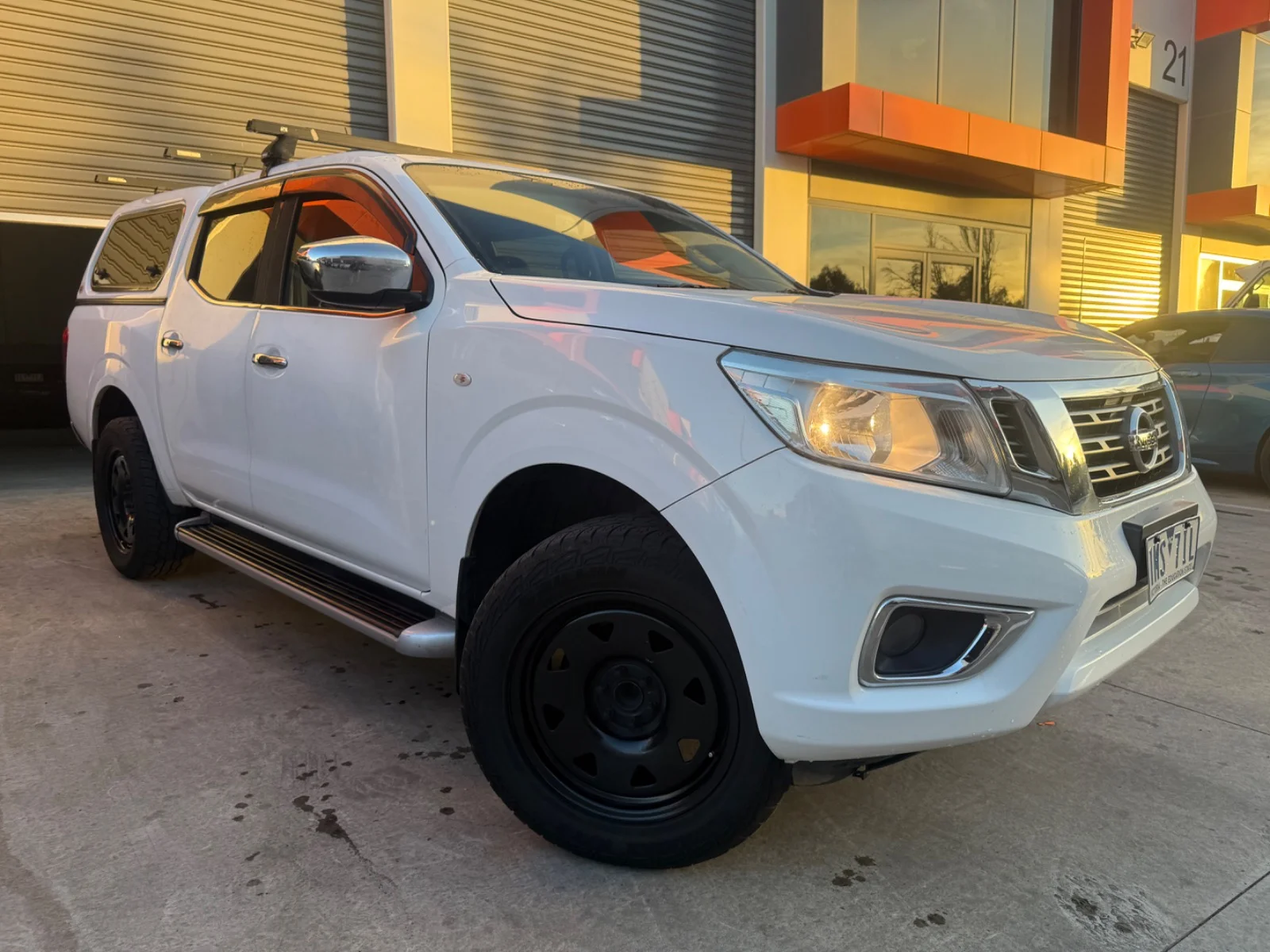 Front three-quarter view of a white 2018 Nissan Navara RX 4x2 dual cab with canopy.