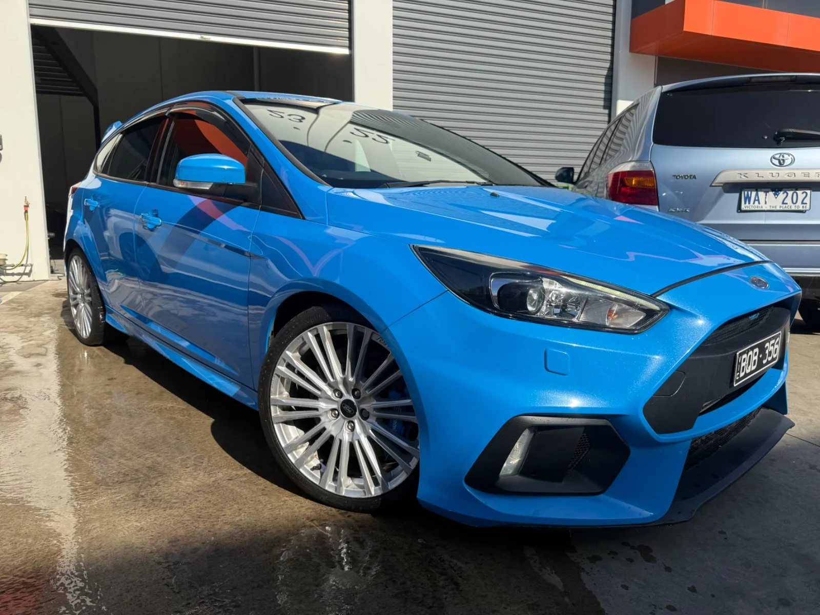 Front three-quarter view of a blue 2017 Ford Focus RS hatch.