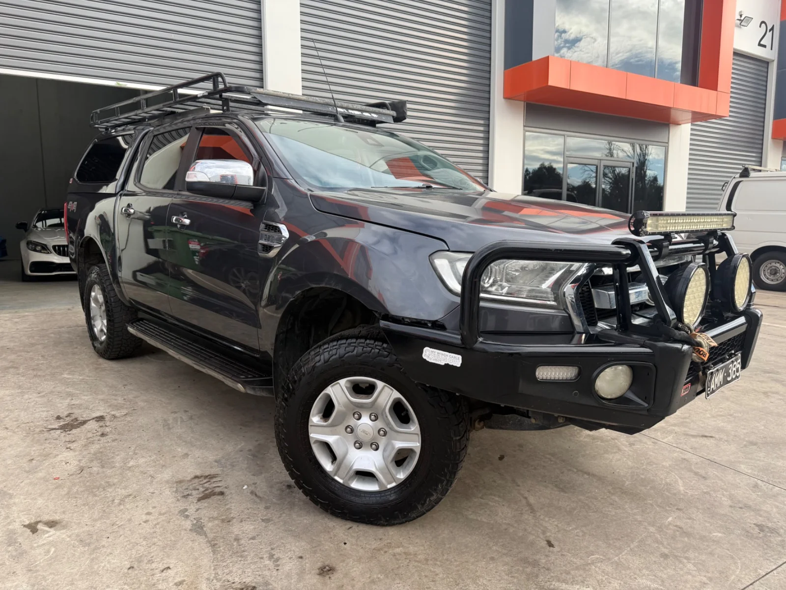 Front three-quarter view of a grey 2016 Ford Ranger XLT dual cab with bull bar and canopy.
