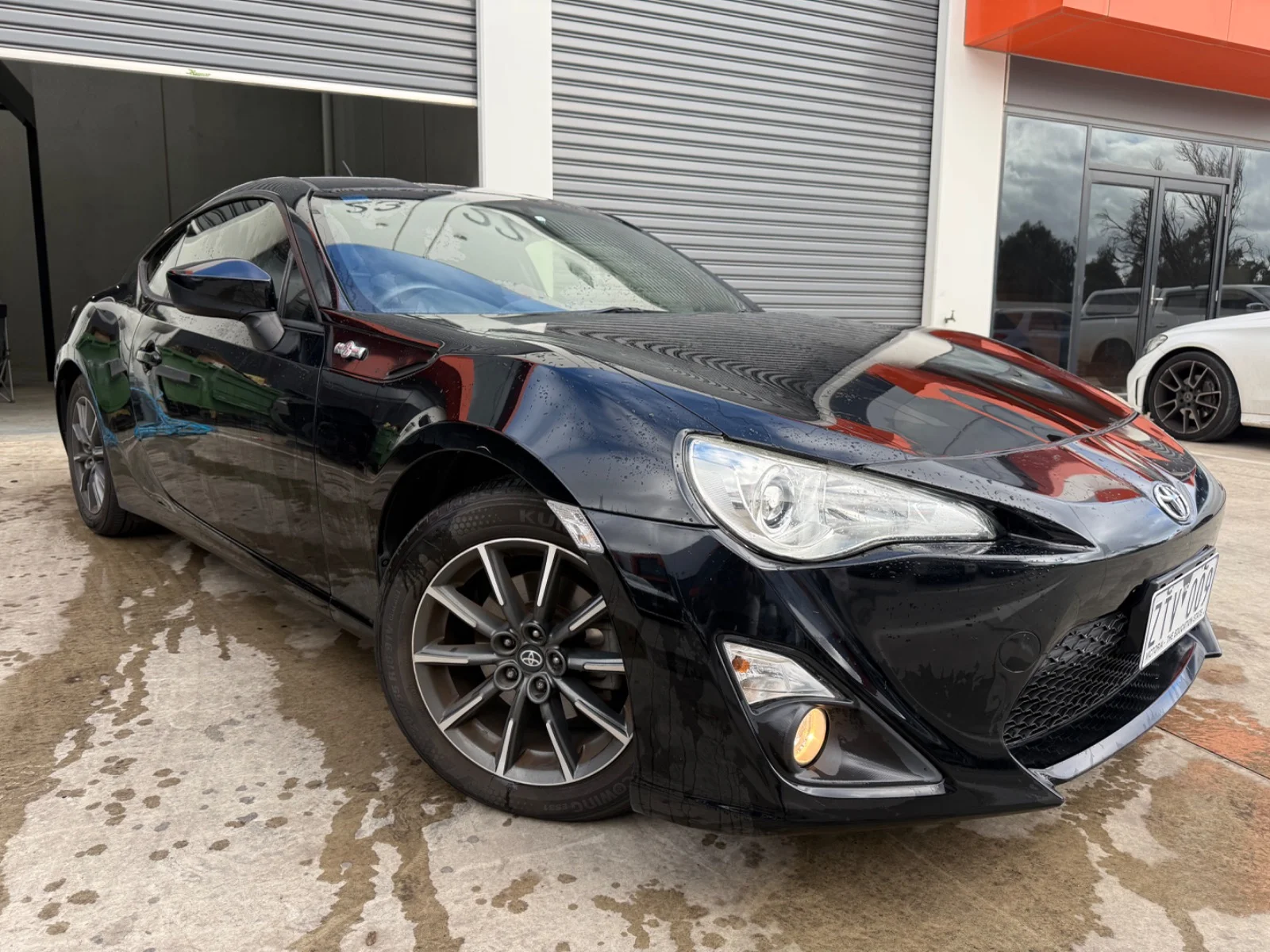 Front three-quarter view of a black 2013 Toyota 86 GT coupe.