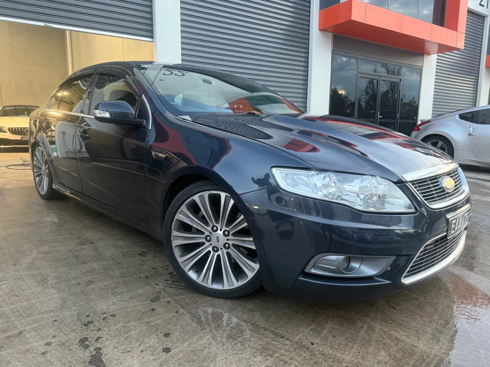 Front three-quarter view of a dark grey 2010 Ford Falcon G6E Turbo sedan.